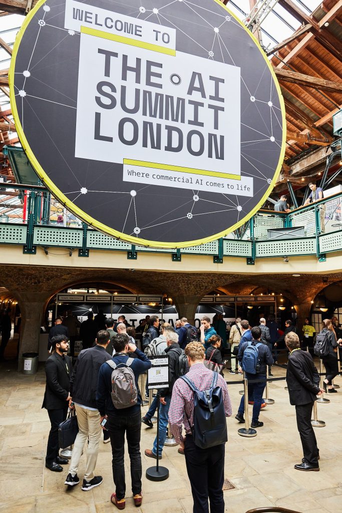 AI Summit London graphic with purple and blue gradient, text 'Register Your Interest', and event branding.