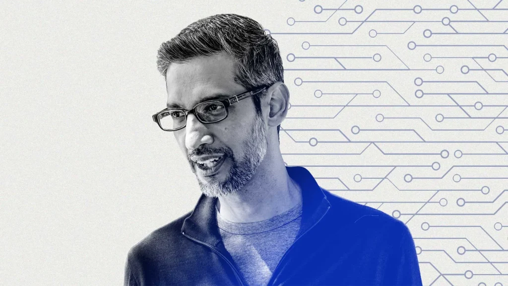 Man in a suit, presumably Google's CEO, speaking at a presentation, with a serious expression. Corporate setting.